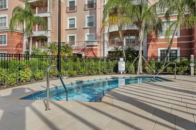 a swimming pool in front of a building at Prime Location 3 Suites Townhome Near Universal in Orlando