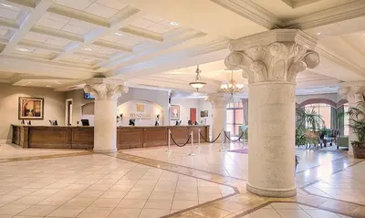 a large lobby with columns and a bar in the background at Bonnet Creek Resort 1 Bedroom 1 BA Deluxe Villa in Orlando