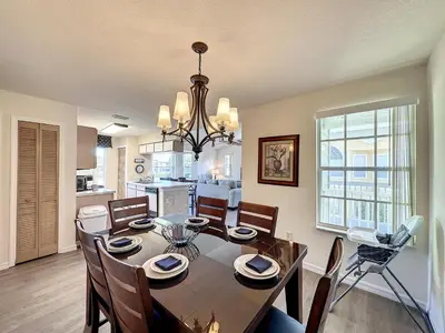 a dining room and kitchen with a table and chairs at Lovely 3 bed Condo Near Disney Quiet Community in Kissimmee