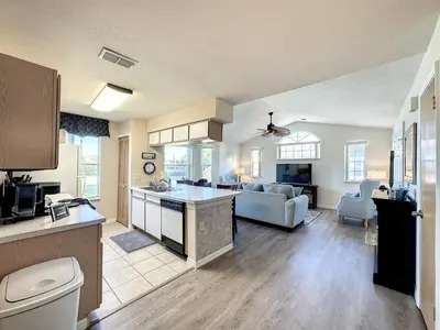 a kitchen and living room with a couch and a table at Lovely 3 bed Condo Near Disney Quiet Community in Kissimmee