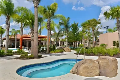 a swimming pool in a resort with palm trees at DLuxx Summer Vacation Home at Solterra Resort 7391 in Orlando