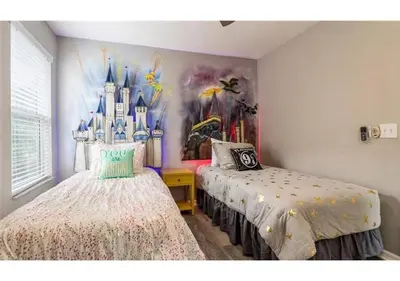 a bedroom with a disney mural on the wall at The Minions Mansion 6br Resort Pool Home By Disney in Kissimmee