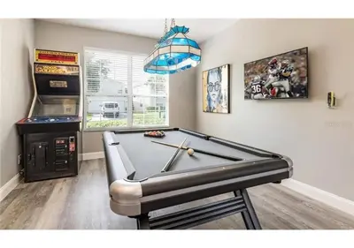 a ping pong table in a room with at The Minions Mansion 6br Resort Pool Home By Disney in Kissimmee
