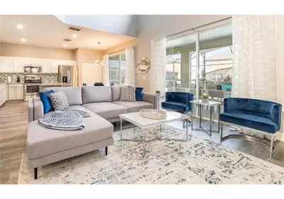 a living room with a couch and a table at The Minions Mansion 6br Resort Pool Home By Disney in Kissimmee