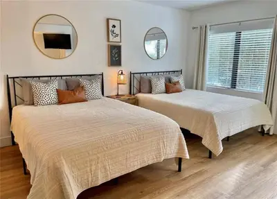 two beds in a bedroom with a mirror at Universal-Disney Dream 1211 Studio - The Enclave in Orlando