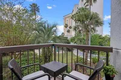 a balcony with chairs and a table and a building at Universal-Disney Dream 1211 Studio - The Enclave in Orlando
