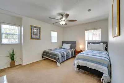 a bedroom with two beds and a ceiling fan at 22 Mi to Disney Kissimmee Home with Pool and Hot Tub in Kissimmee