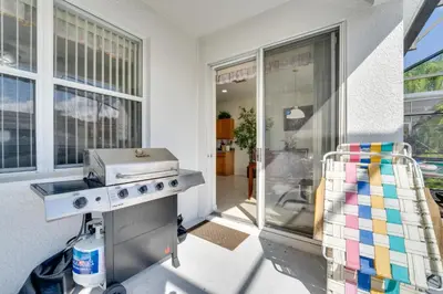 a kitchen with a grill in front of a window at 22 Mi to Disney Kissimmee Home with Pool and Hot Tub in Kissimmee