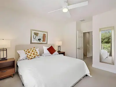 a white bedroom with a white bed and a window at MEMO Vacation House in Orlando