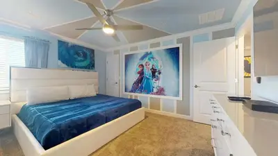 a bedroom with a bed and a painting on the wall at 4323SL-Storey Lake Resort townhouse in Kissimmee