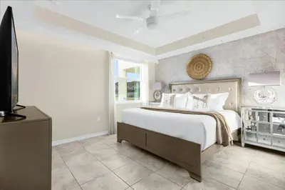 a bedroom with a large bed and a television at 3 Bedrooms 2 Bathrooms Storey Lake 3111-101Pc in Kissimmee