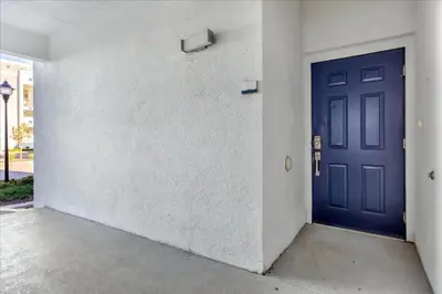 a blue door on the side of a building at 3 Bedrooms 2 Bathrooms Storey Lake 3111-101Pc in Kissimmee