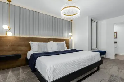a bedroom with a large bed and a chandelier at 5 Bedrooms 4 Bathrooms Storey Lake 2533 Rt in Kissimmee