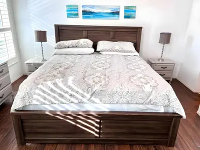 a bedroom with a large bed with two night stands at Brittany - Perfect 3 BR Pool Home in Kissimmee