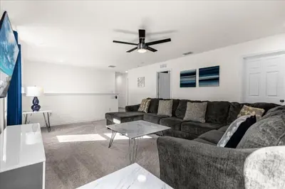 a living room with a couch and a ceiling fan at 6 Bedrooms 5 Bathrooms Solara 1889 Tp in Orlando