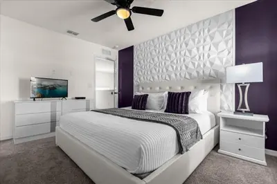 a bedroom with a white bed and a ceiling fan at 6 Bedrooms 5 Bathrooms Solara 1889 Tp in Orlando