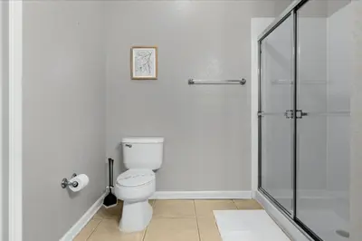 a bathroom with a toilet and a glass shower at 3 Bedrooms 2 Bathrooms Vista Cay 4024-203 Bd in Orlando