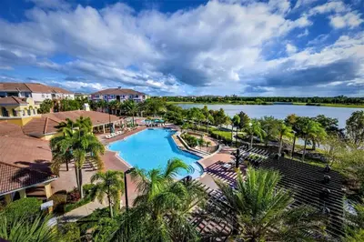 an aerial view of a resort with a swimming pool and a lake at 3 Bedrooms 2 Bathrooms Vista Cay 4024-203 Bd in Orlando