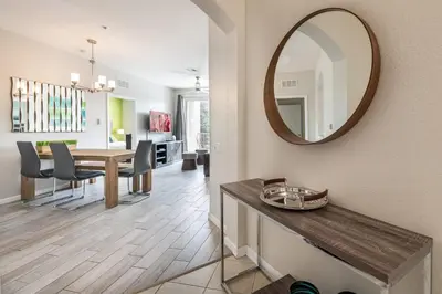 a dining room with a table and a mirror at Near Pool*Balcony*VistaCay Convention Ctr & Idrive in Orlando