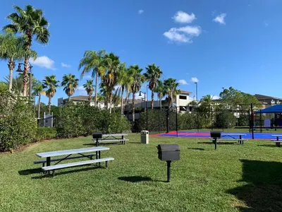 a group of picnic tables in a park with palm trees at Near Pool*Balcony*VistaCay Convention Ctr & Idrive in Orlando