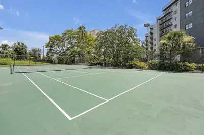 a tennis court with two tennis rackets on it at Enclave Refurbished Condo: Just 2mi to Universal! in Orlando