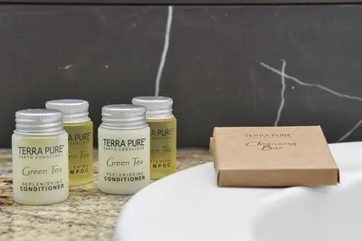 four jars of green paint sitting next to a box at Enclave Refurbished Condo: Just 2mi to Universal! in Orlando