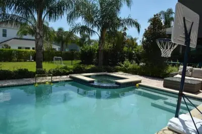 a large swimming pool with a basketball hoop at Reunion Encore Resort Villa W/ Pool Spa Gameroom in Orlando