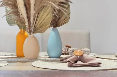 a table with four vases sitting on a table at Remodeled Retreat: Tranquil Resort Oasis Near Theme Parks in Kissimmee