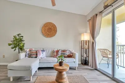 a living room with a couch and a table at Remodeled Retreat: Tranquil Resort Oasis Near Theme Parks in Kissimmee