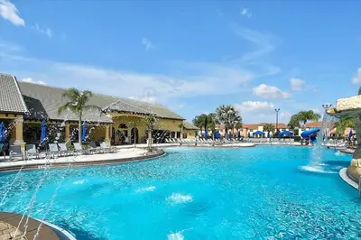 a swimming pool with blue water in a resort at Just renovated, private heated pool, resort access in Kissimmee