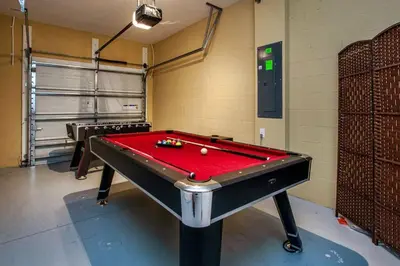 a pool table in a room with a red cover at Fancy Family Home 10min-Disney Private Pool STL108 in Kissimmee