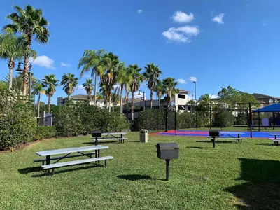 a group of picnic tables in a park with palm trees at Top Floor*Balcony*VistaCay Convention Ctr & Idrive in Orlando