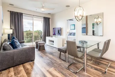 a living room with a glass table and a couch at Pool*Top Floor*Forest Views*Balcony*VistaCay in Orlando
