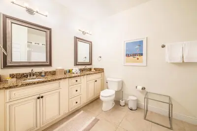 a bathroom with a toilet and a sink and a mirror at Top Floor*Balcony*VistaCay Convention Ctr & Idrive in Orlando