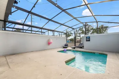 an indoor swimming pool with a glass ceiling at 4BR Pool Home w Free Waterpark - 9 Min to Disney in Kissimmee