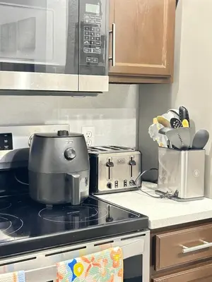 a kitchen with a stove and a microwave at Your home 5 * near Disney in Kissimmee