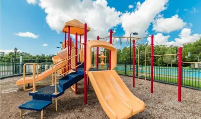 a playground with an orange and blue slide at Your home 5 * near Disney in Kissimmee