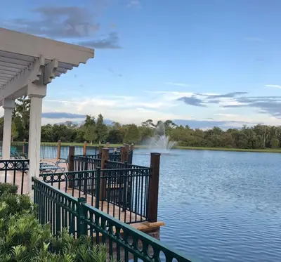 a bridge over a lake with a fountain in the distance at Your home 5 * near Disney in Kissimmee