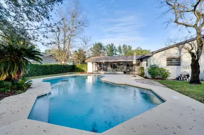 a swimming pool in the backyard of a house at 7 Mi to Disney World Orlando Home with Private Pool in Orlando