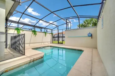 an indoor swimming pool with a glass roof at Lovely Family Home - 10min to Disney - STL107 in Kissimmee