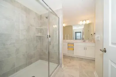 a bathroom with a shower with a glass door at 3121-304FR STOREY LAKE, CONDO 2/2 LAKE VIEW in Kissimmee
