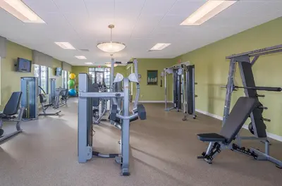 a gym with several tread machines in a room at 3131-102JJ STOREY LAKE, CONDO 2/2 LAKE VIEW in Kissimmee