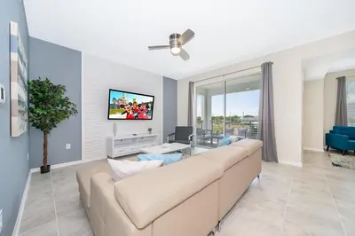 a living room with a couch and a tv at 3141-202RF STOREY LAKE, CONDO 2/2 LAKE VIEW in Kissimmee