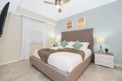 a bedroom with a large bed and a window at 3141-202RF STOREY LAKE, CONDO 2/2 LAKE VIEW in Kissimmee