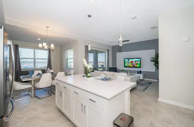 a kitchen and dining room with a white counter top at 3141-405IL STOREY LAKE, CONDO 2/2 LAKE VIEW in Kissimmee
