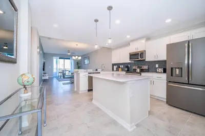 a kitchen with white cabinets and stainless steel appliances at 3131-305RA STOREY LAKE, CONDO 2/2 LAKE VIEW in Kissimmee