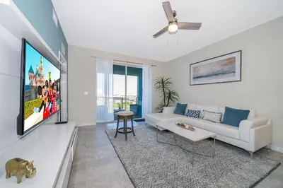 a living room with a couch and a ceiling fan at 3131-305RA STOREY LAKE, CONDO 2/2 LAKE VIEW in Kissimmee