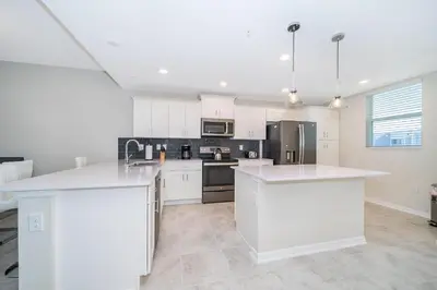 a kitchen with white cabinets and white counter tops at 3131-305RA STOREY LAKE, CONDO 2/2 LAKE VIEW in Kissimmee