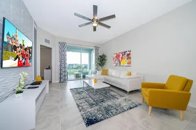 a living room with a couch and a ceiling fan at 3161-308AB STOREY LAKE, CONDO 3/2 LAKE VIEW in Kissimmee