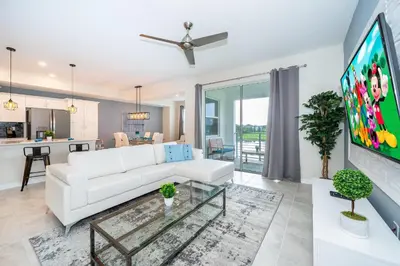 a living room with a white couch and a tv at 3151-207NC STOREY LAKE, CONDO 2/2 LAKE VIEW in Kissimmee